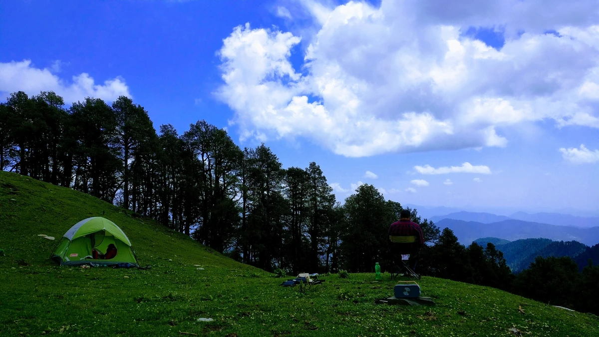 A tent pitched on the meadow at Jalori Pass under a wide sky