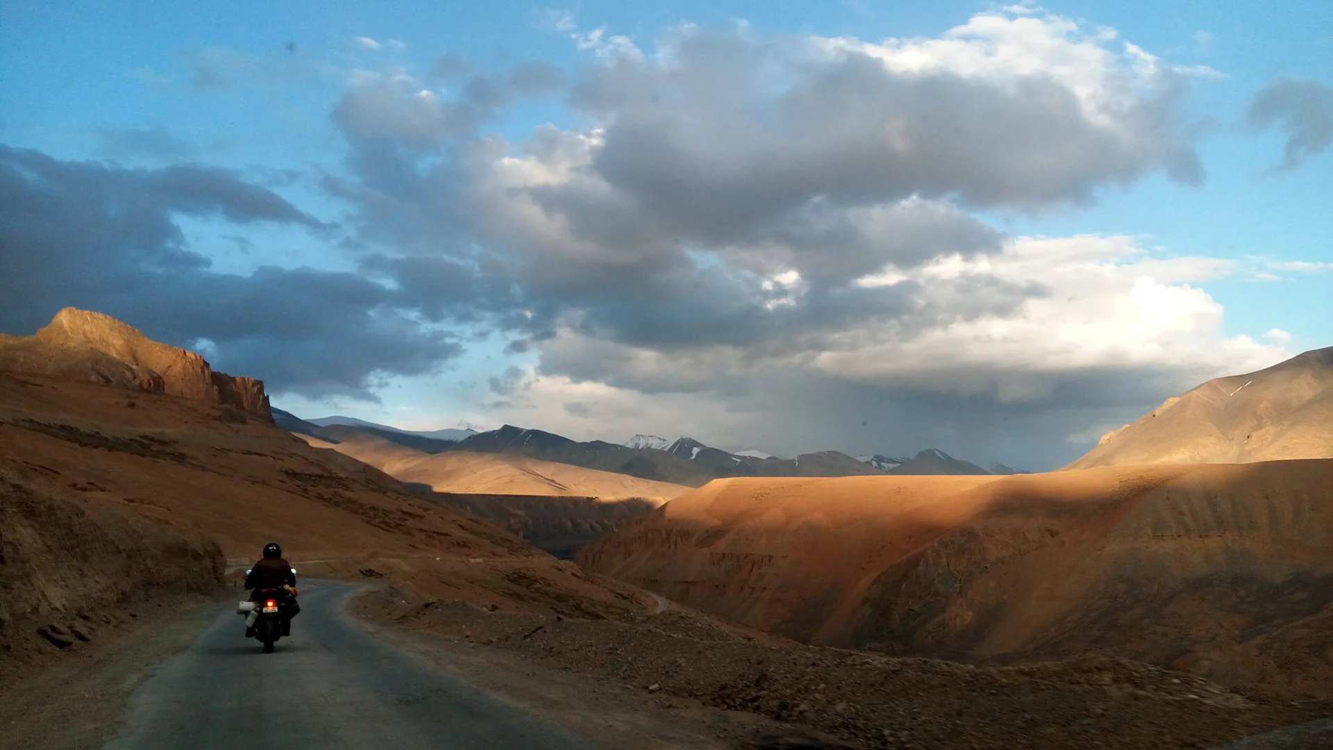 A rider on the road through the canyons near Pang