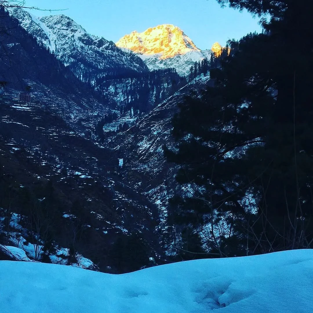Last light on a peak above the snow