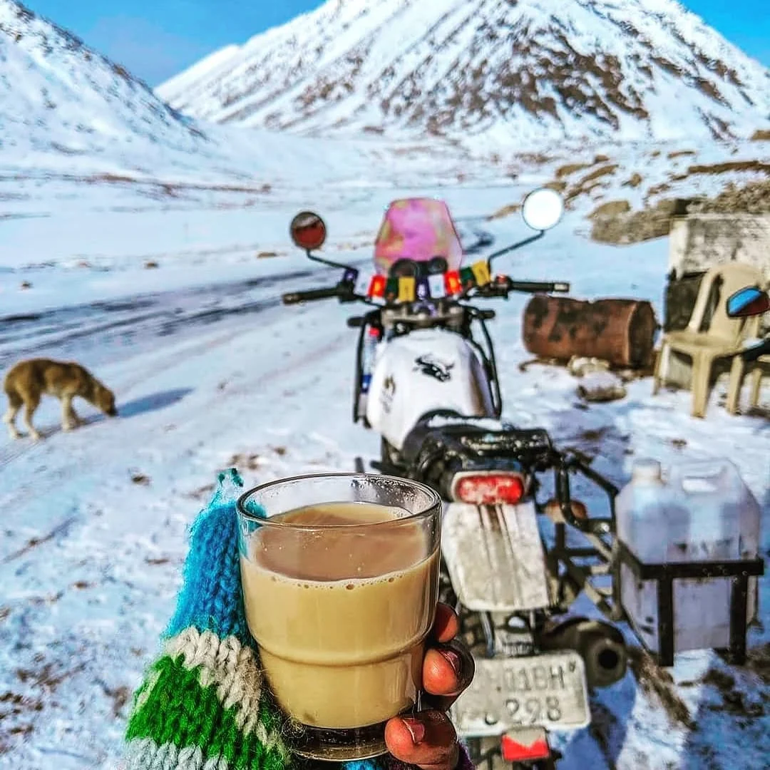A motorbike, chai and a snowy pass