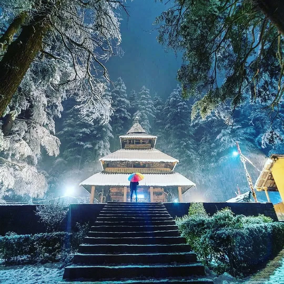 Hadimba temple lit up on a snowy night