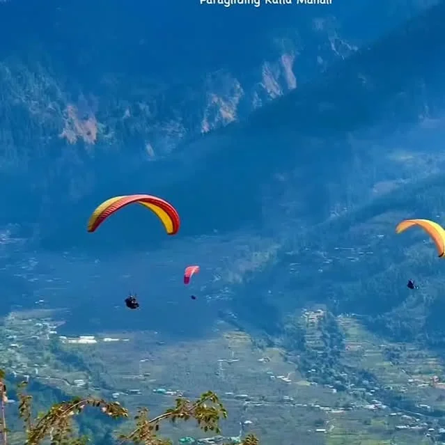 Paragliders over the Dobhi slopes