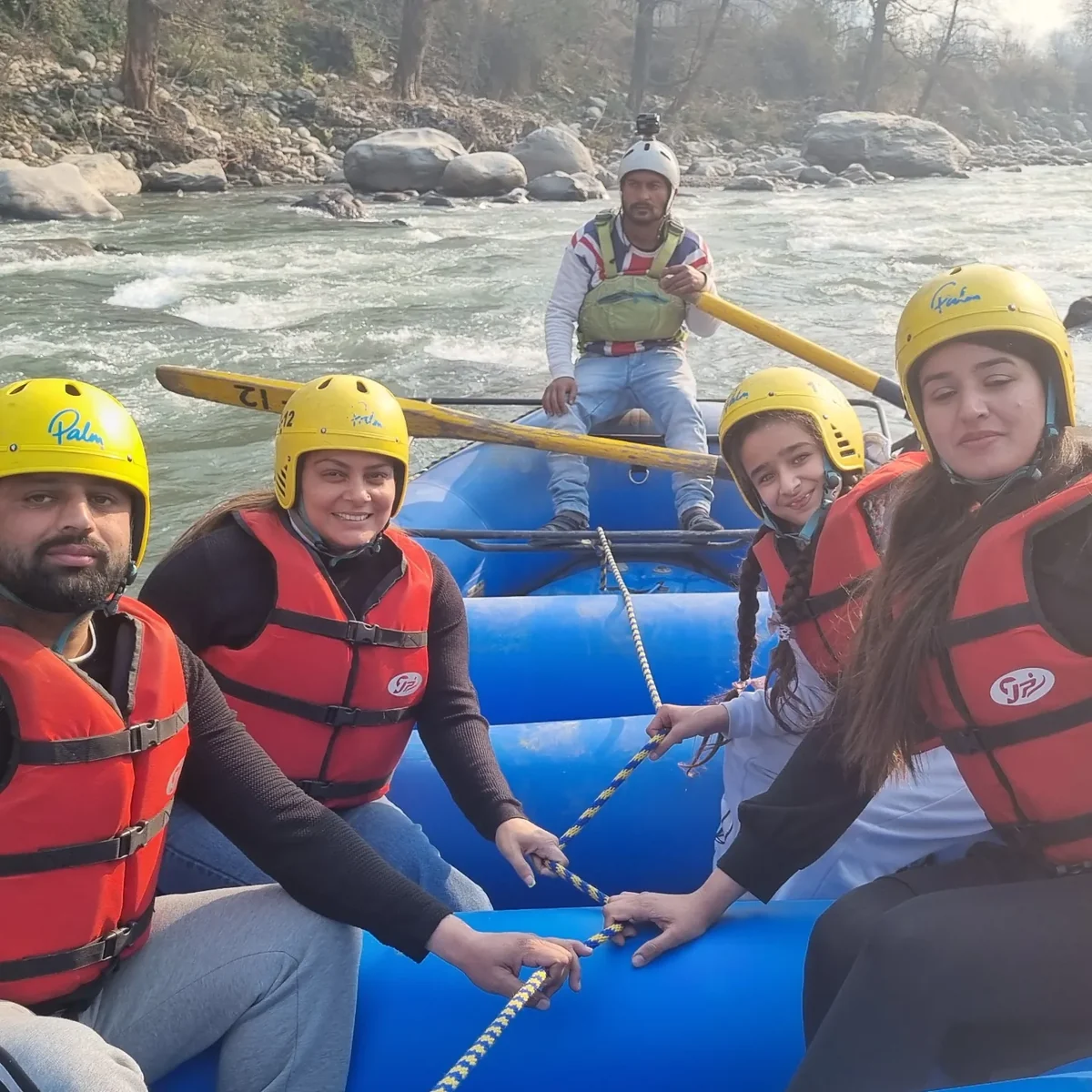 Rafters ready in the boat, paddles in hand