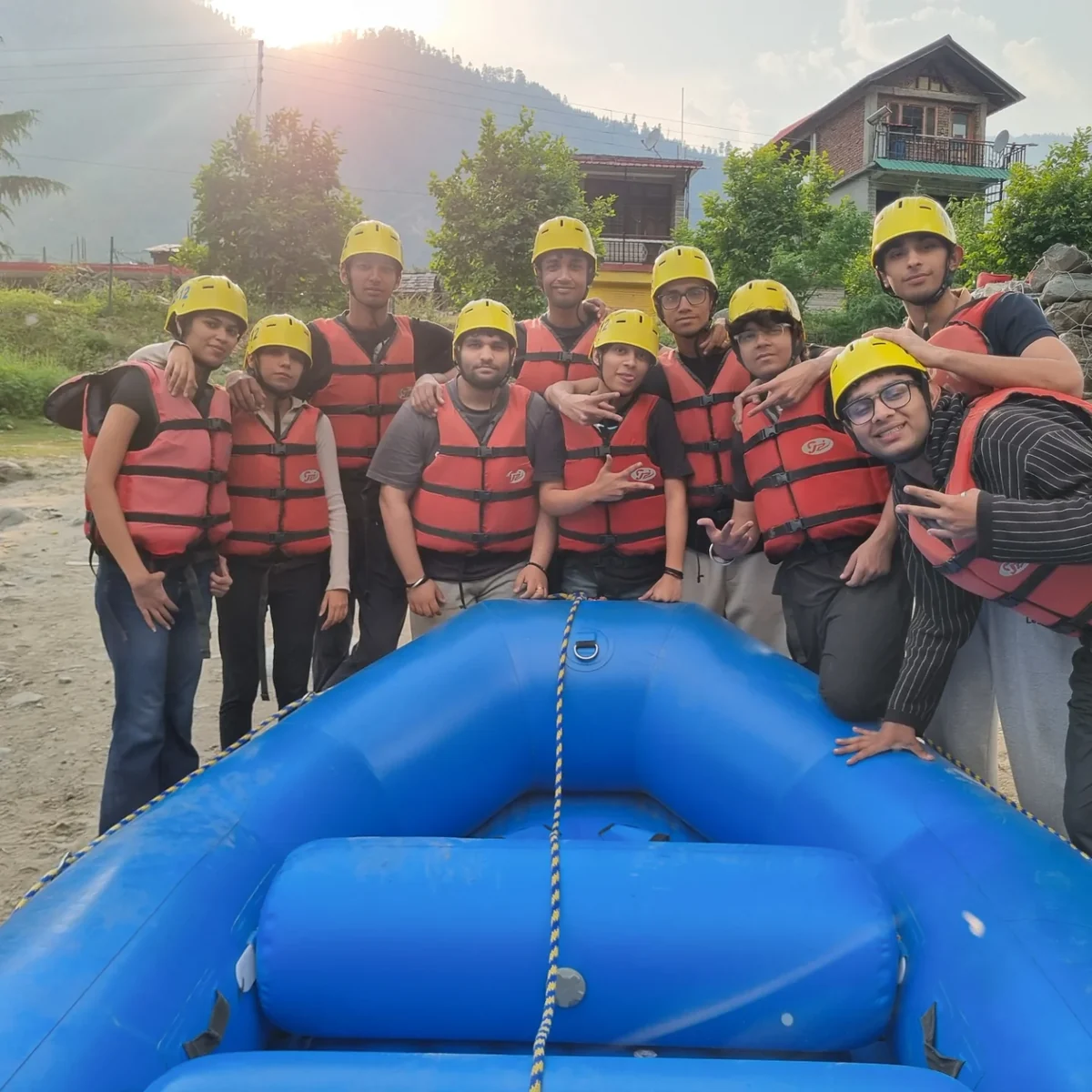 A rafting group in helmets beside their raft