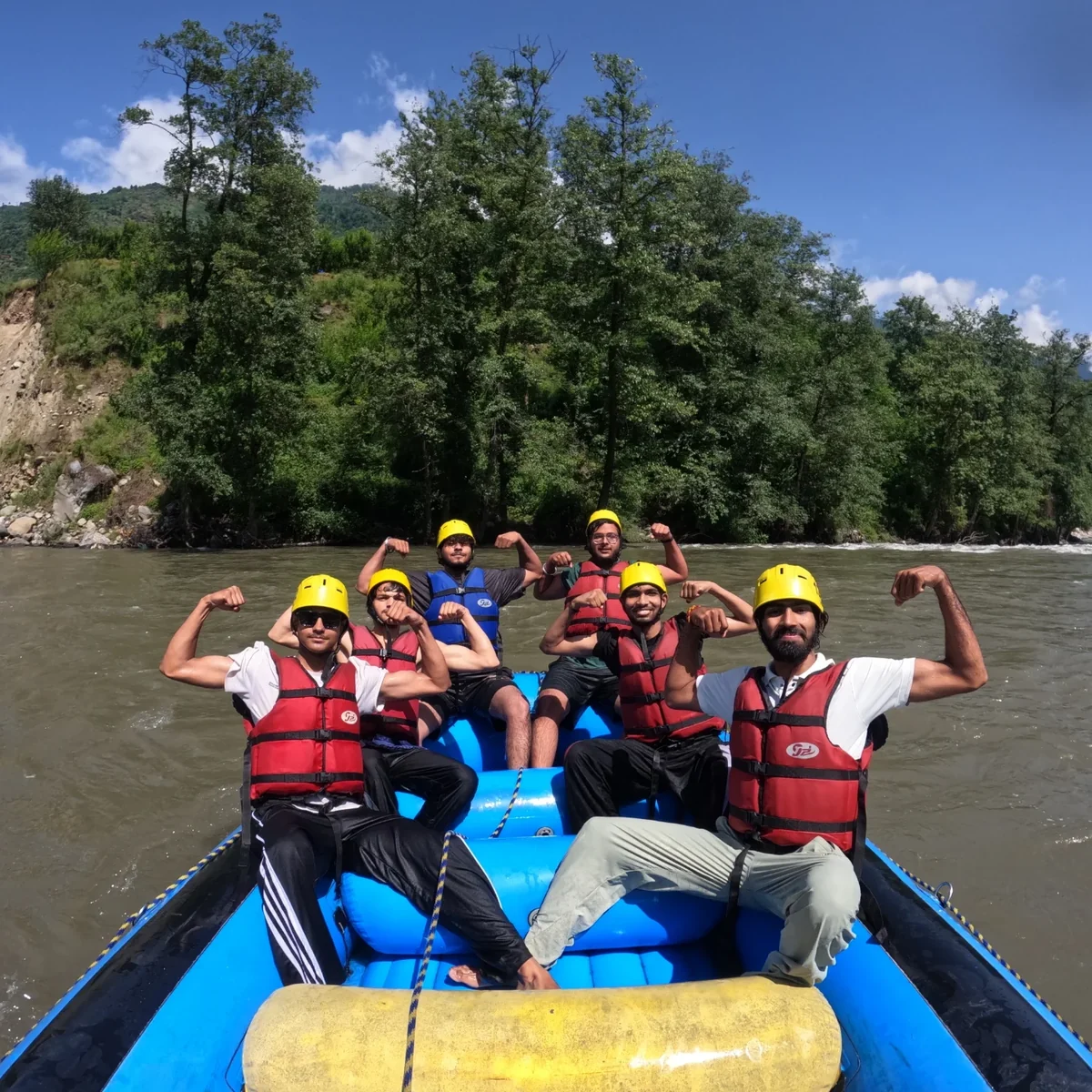 A Manali Trails raft crew flexing on the Beas