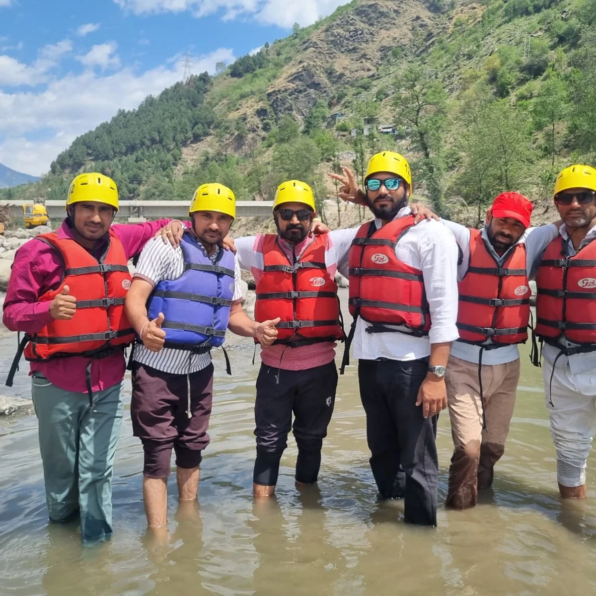 A rafting group standing in the shallows