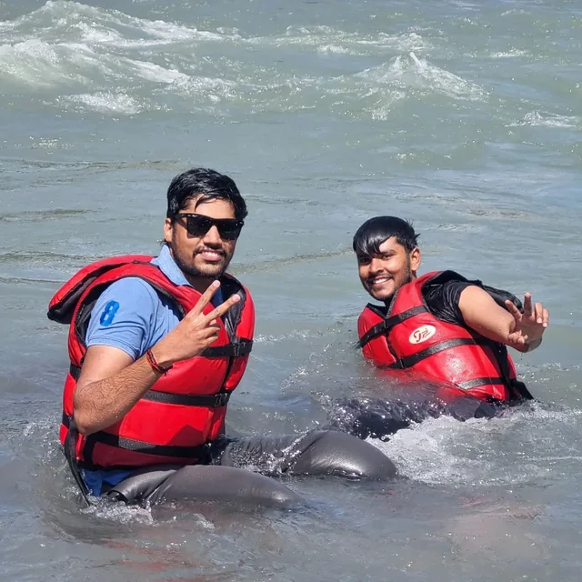 Two rafters floating in the Beas in life jackets