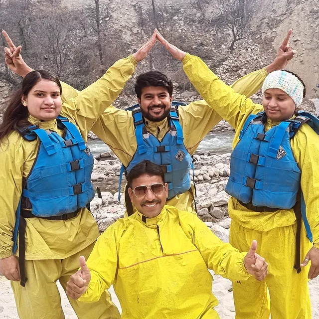 Rafters in yellow splash suits and blue life jackets