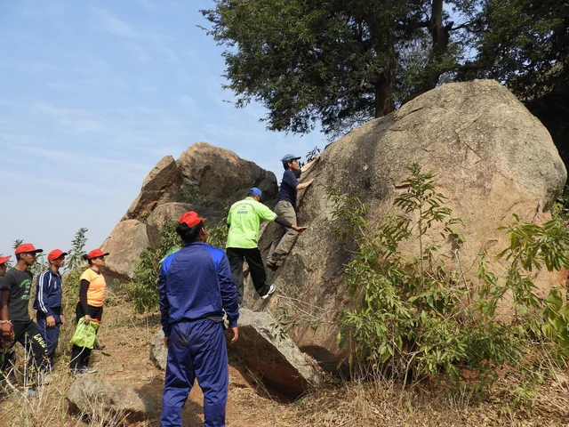 A climbing lesson on a granite boulder