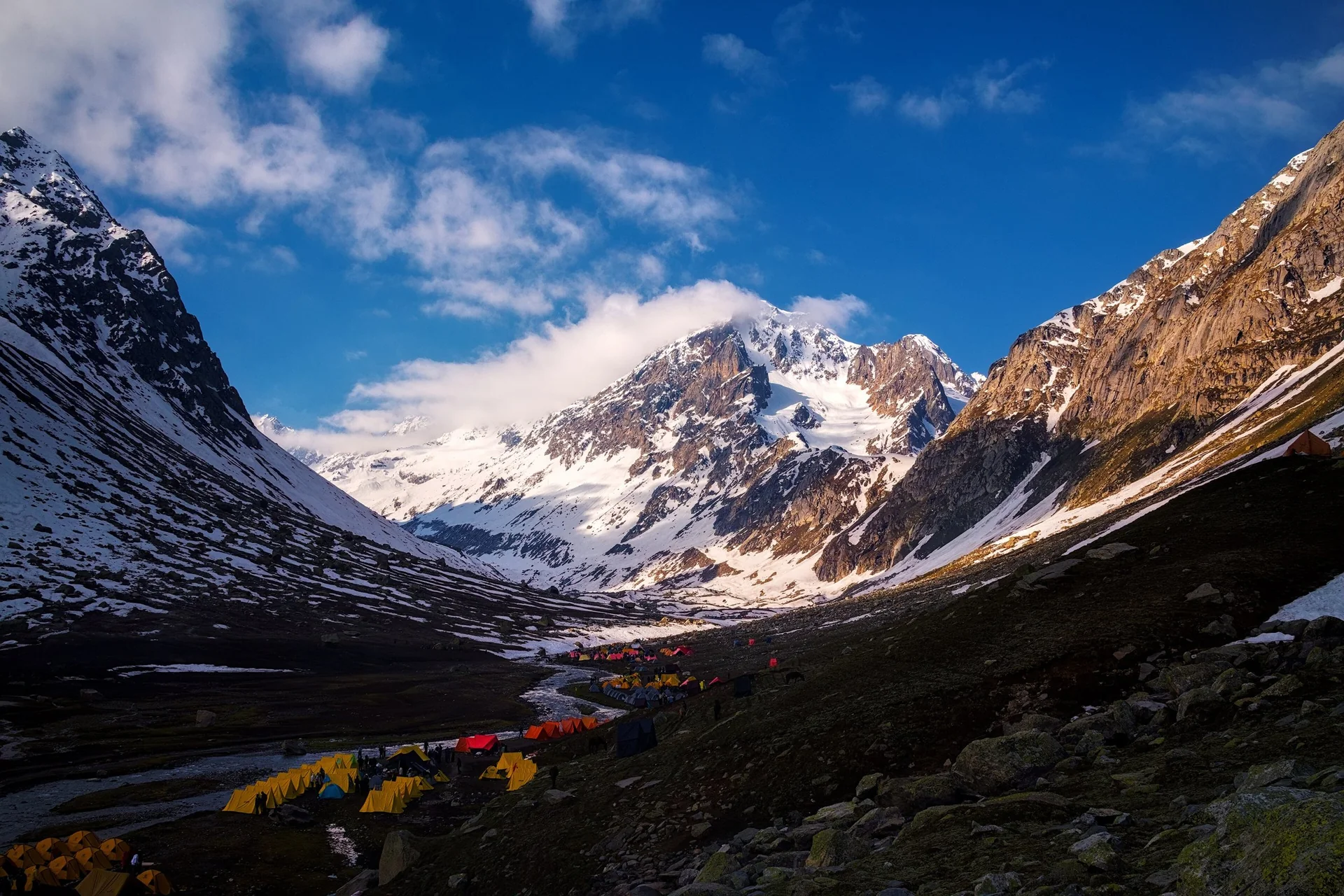 Camp at Shea Goru below the Hampta Pass, snow peaks behind