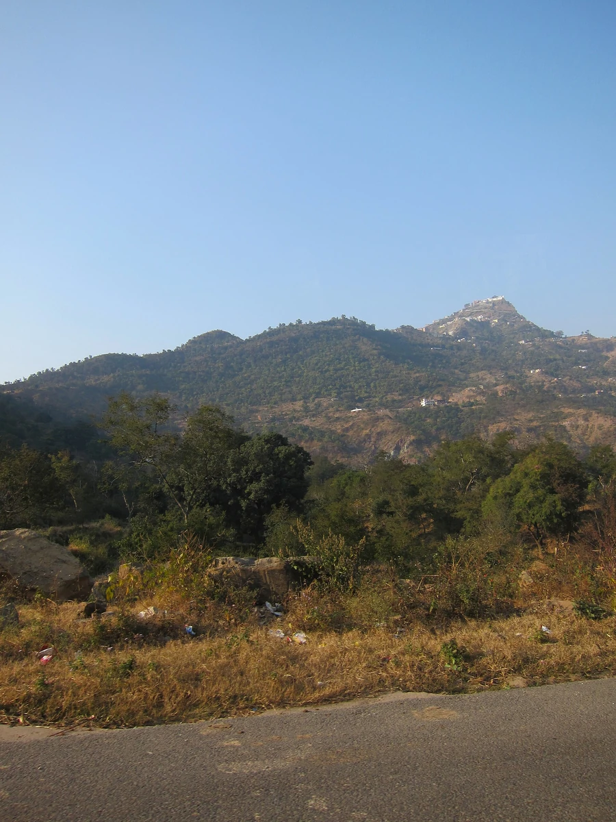 The white temple buildings of Shri Naina Devi Ji on the top of a hill