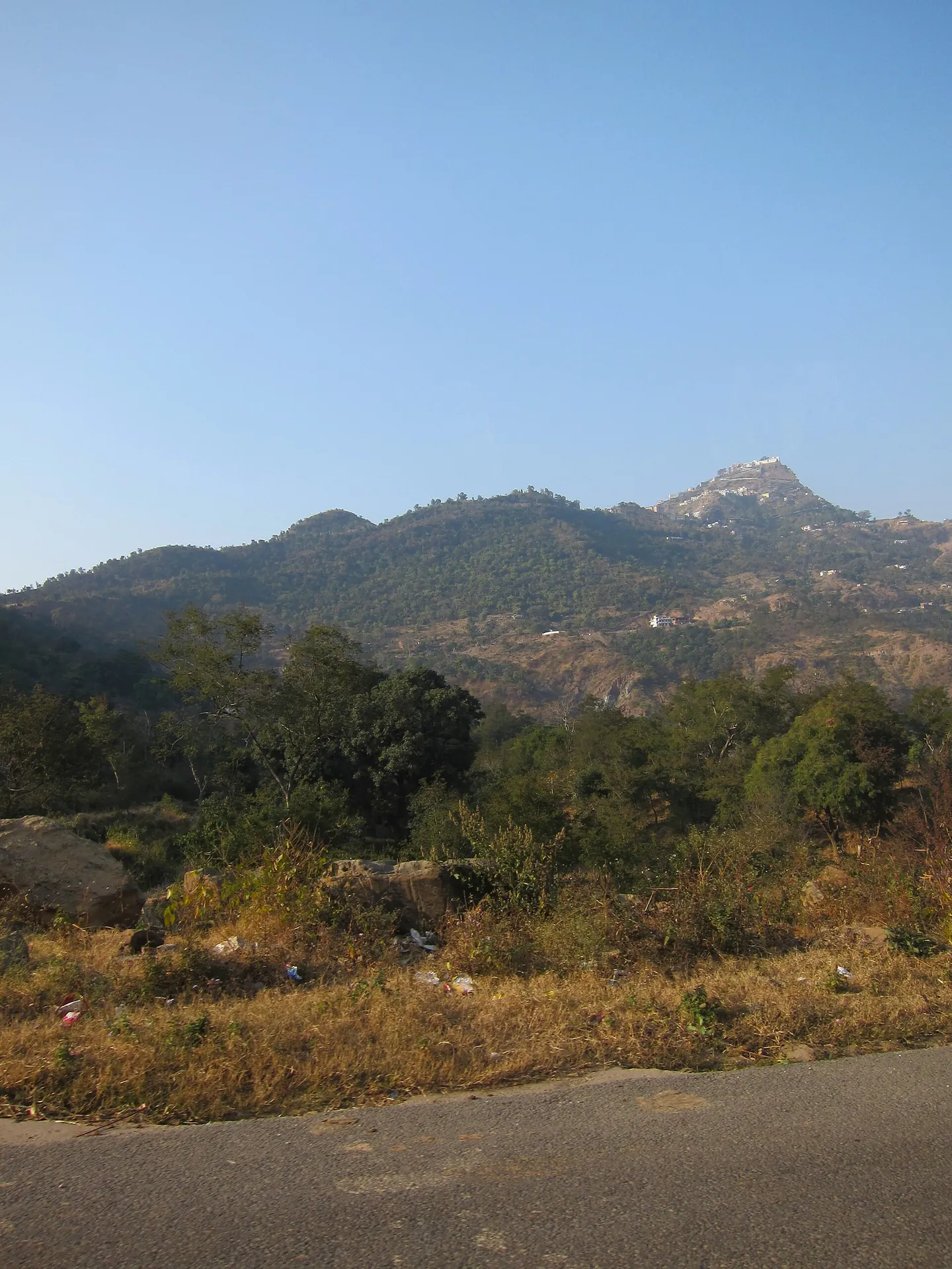 The white temple buildings of Shri Naina Devi Ji on the top of a hill
