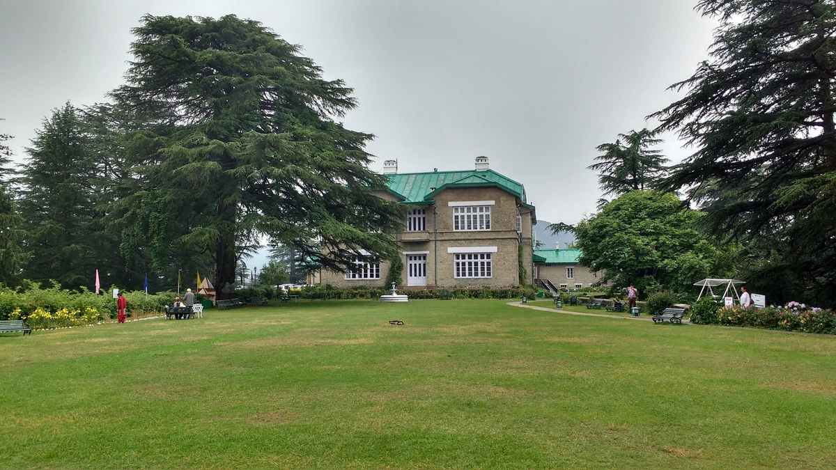 The Chail Palace behind a wide lawn and tall deodar trees