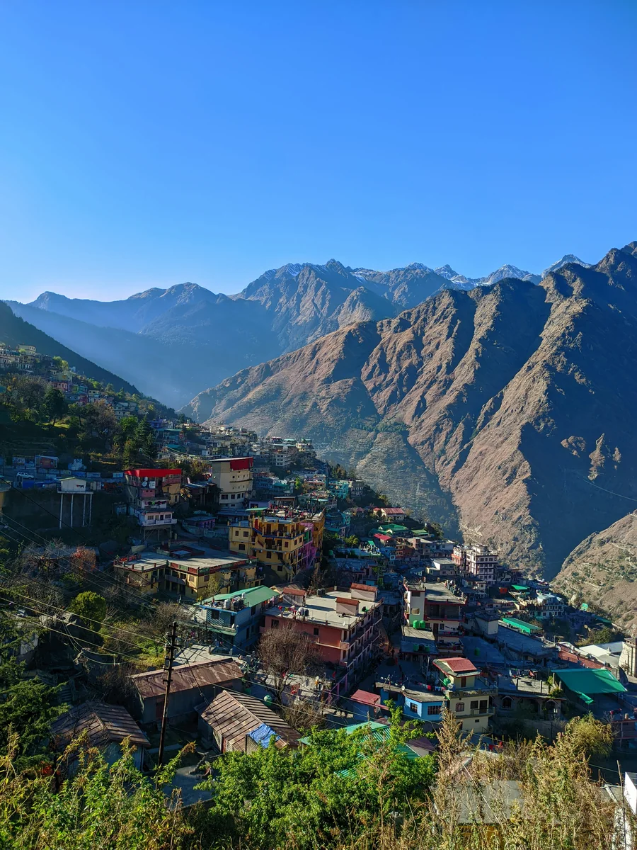 Joshimath's houses spread down a steep mountain slope above a deep valley