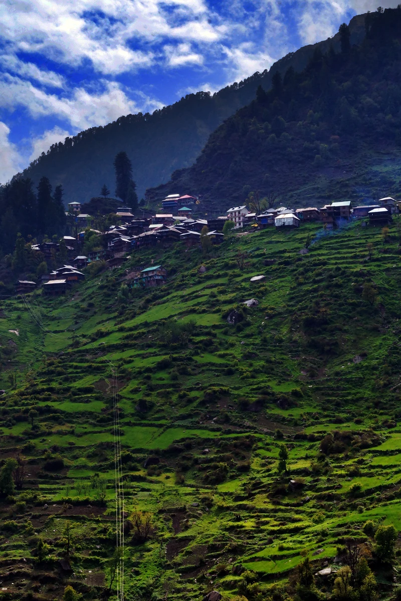 Malana village on its green slope high above the gorge