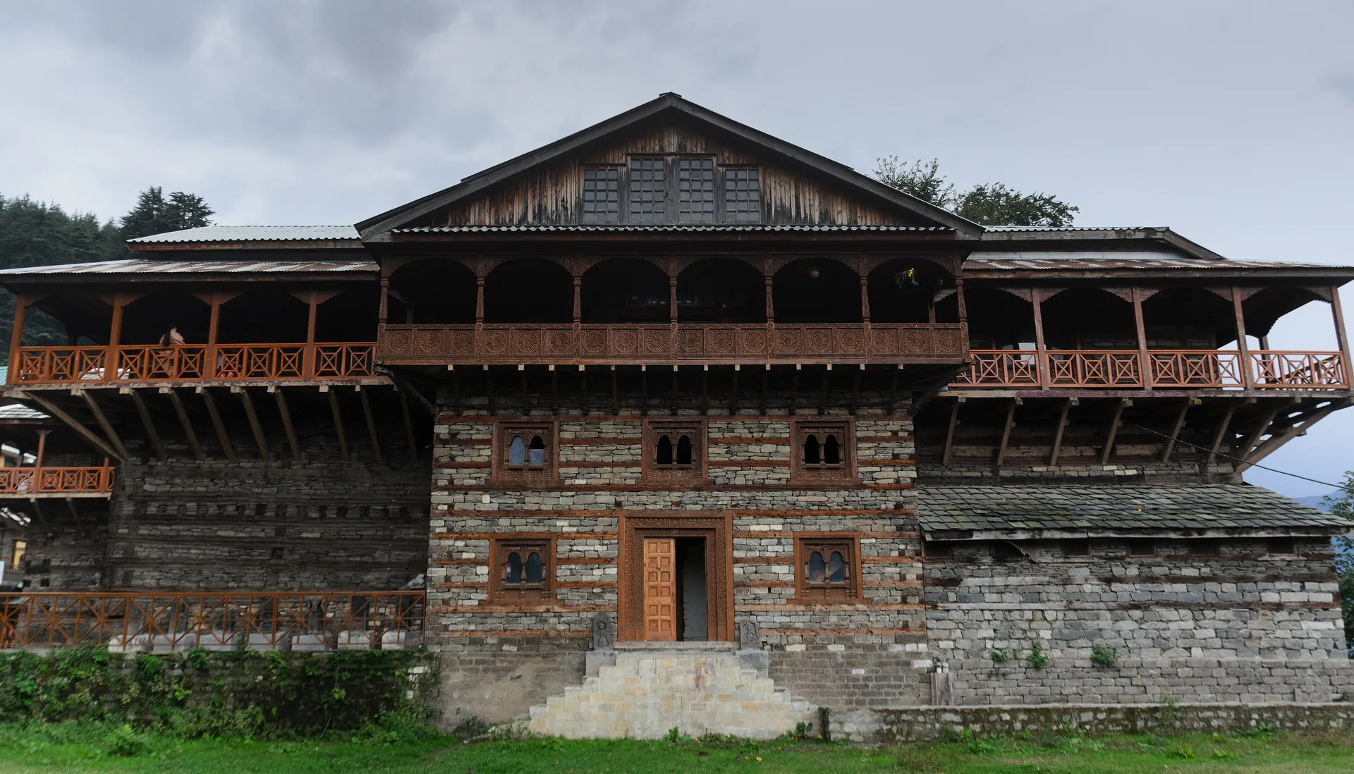 The wood-and-stone front of Naggar Castle under its slate roof