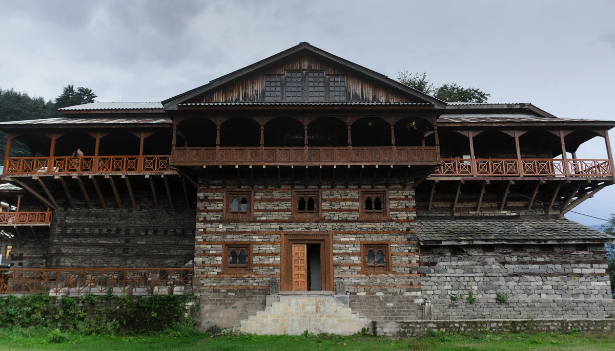 The wood-and-stone front of Naggar Castle under its slate roof