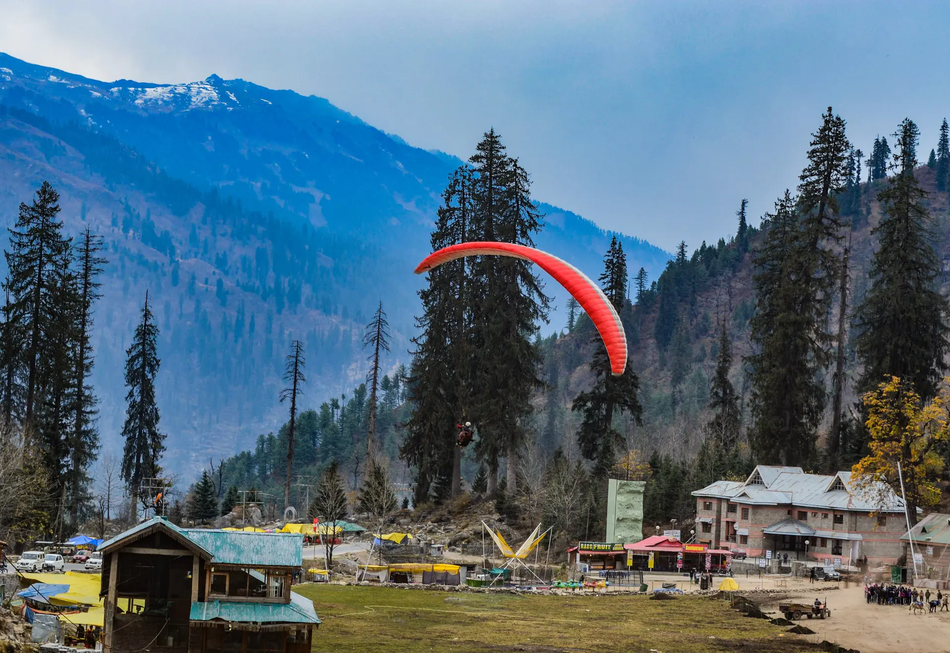 Paragliders landing at Solang's meadow