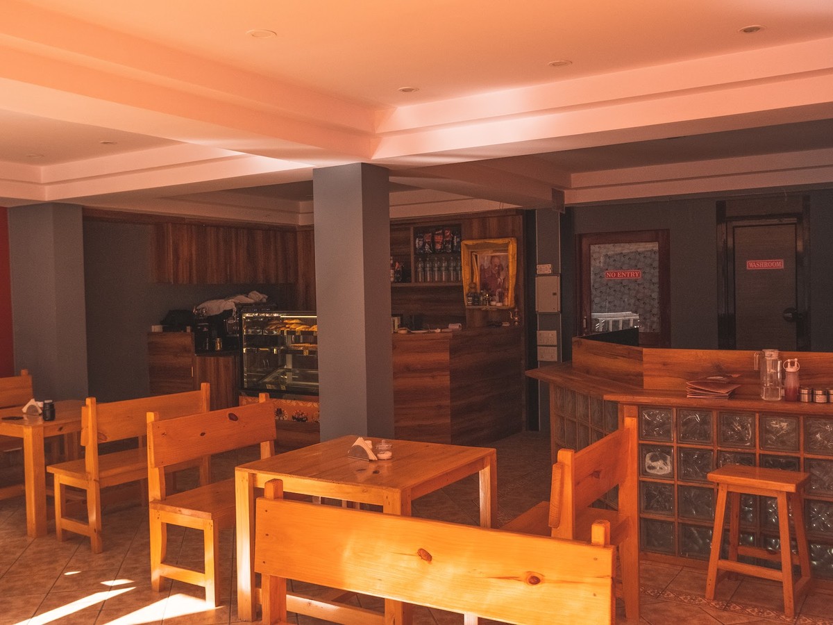 Inside the café — wooden tables and the bar