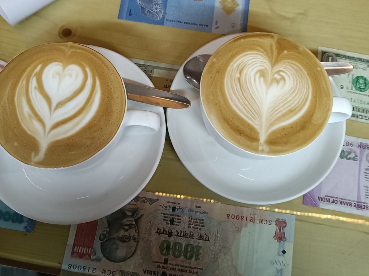 Two cappuccinos with latte art