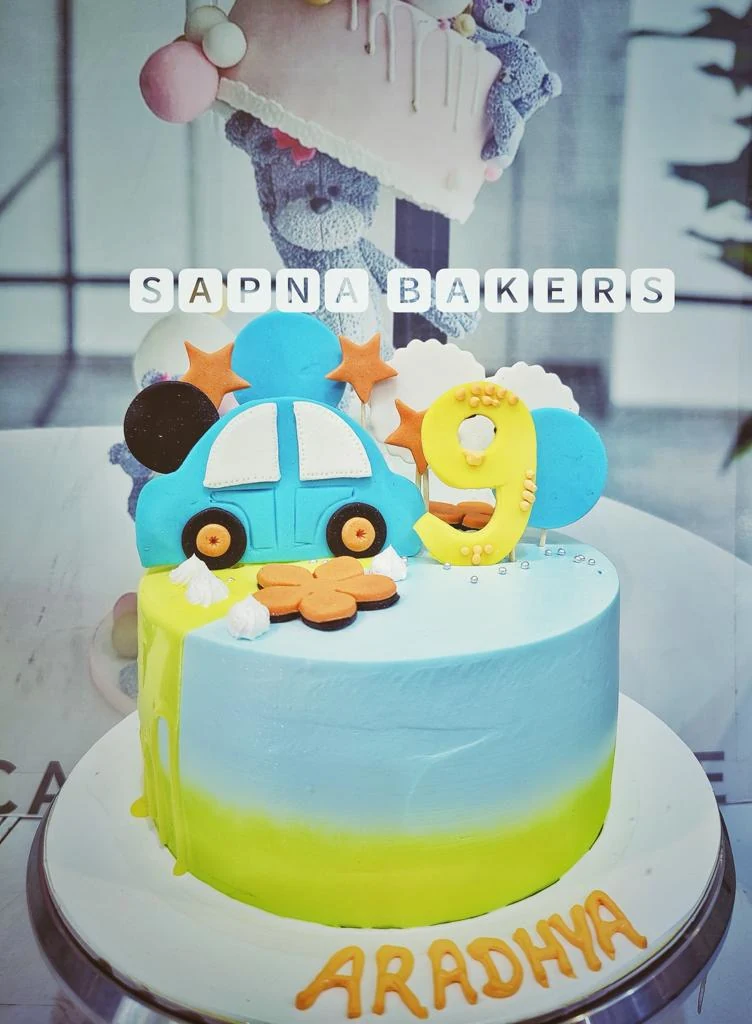 A blue cake with a car and the number nine
