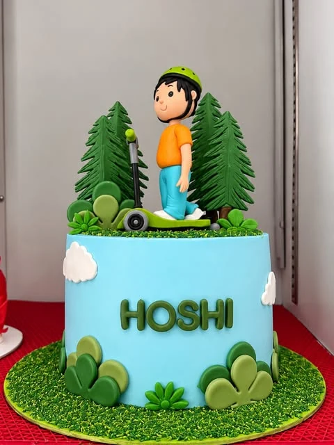 A forest cake with a boy on a skateboard