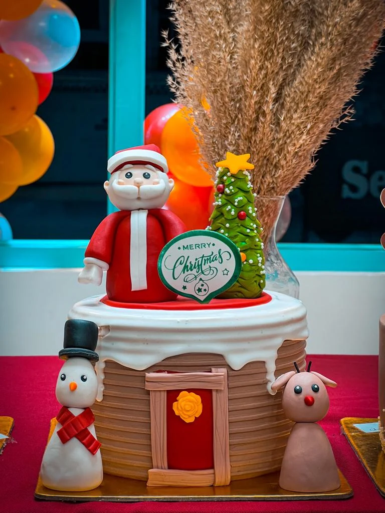 A Christmas cake with Santa and a snowman