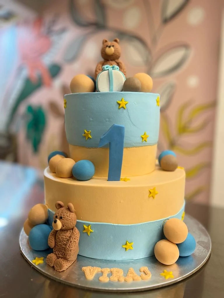 A first-birthday cake with teddy bears and stars