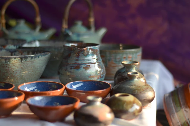 Glazed Andretta pottery bowls, jugs and teapots displayed on a table