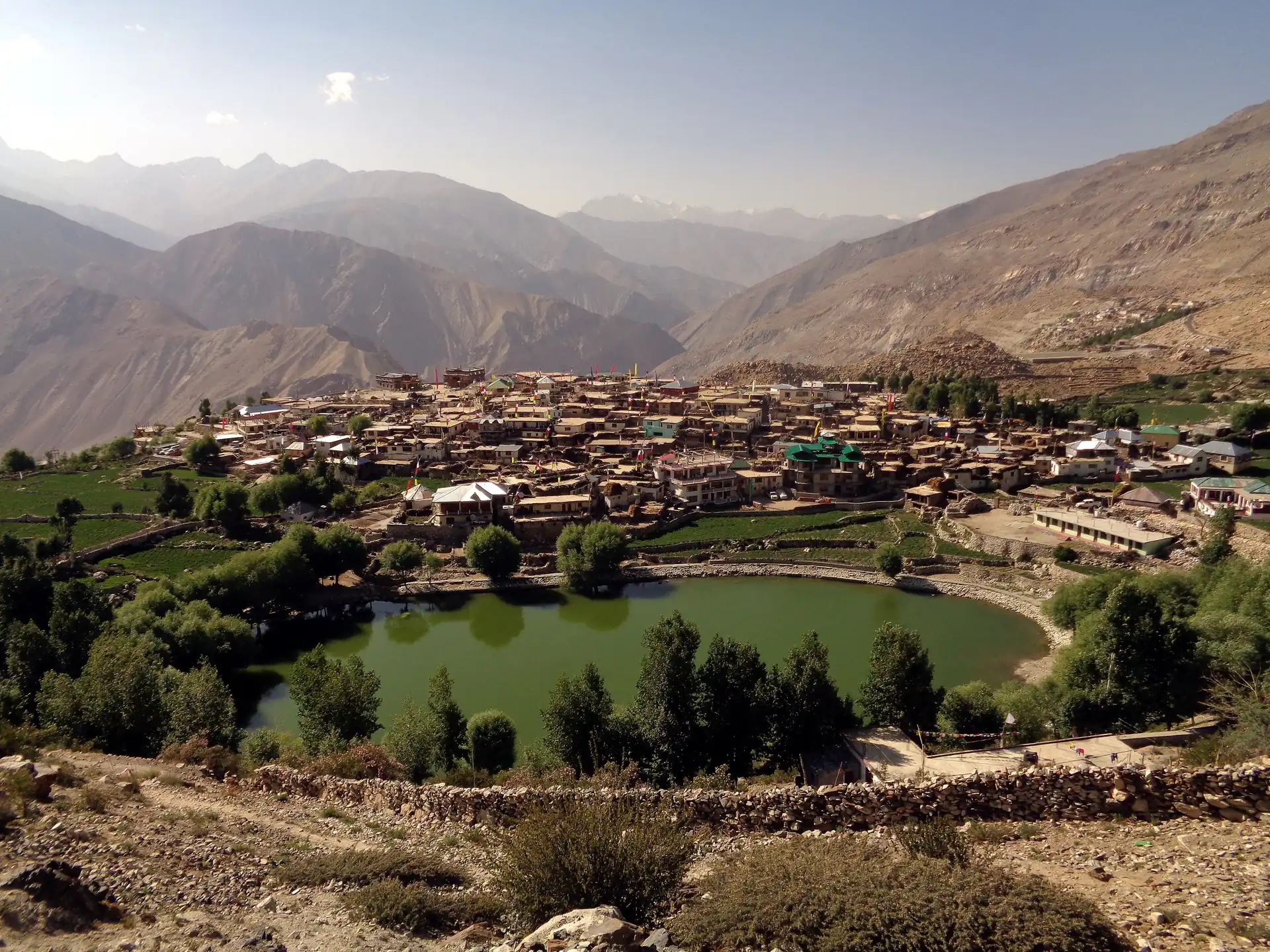 Nako village and its small green lake on a bare mountain slope in Kinnaur
