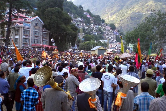 The main procession at Kullu Dussehra, with deities in palanquins and a crowd on the Dhalpur ground