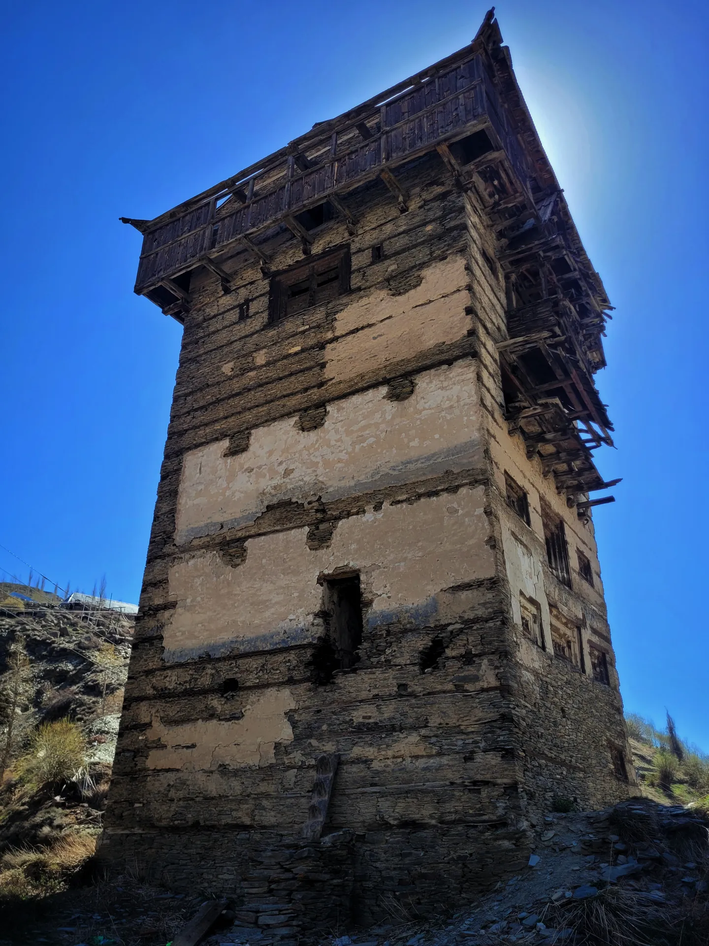 The tall timber-and-stone tower of Gondhla Fort rising against a blue sky