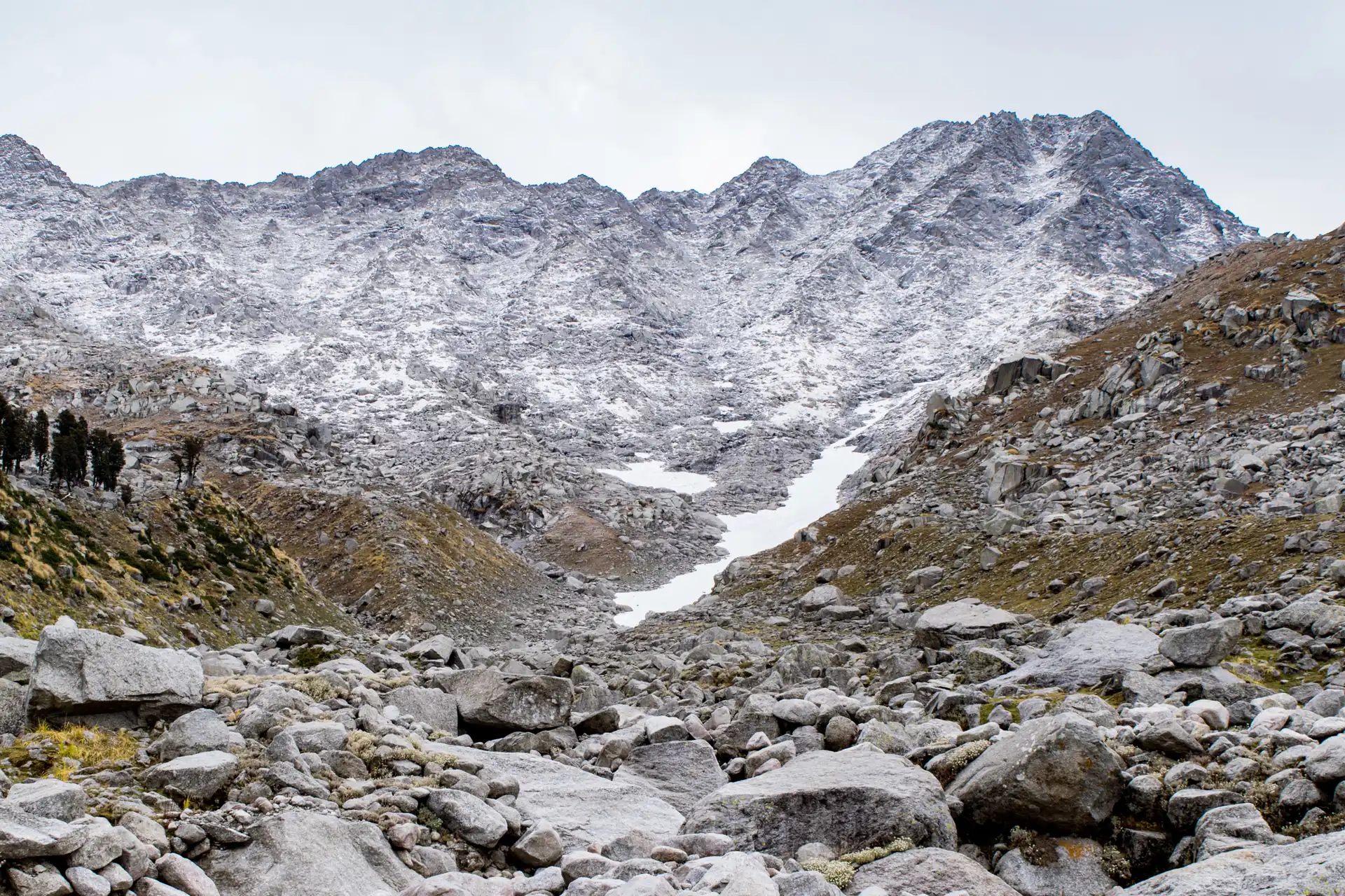 Snow-dusted rocky slopes rising to the Indrahar Pass in the Dhauladhar