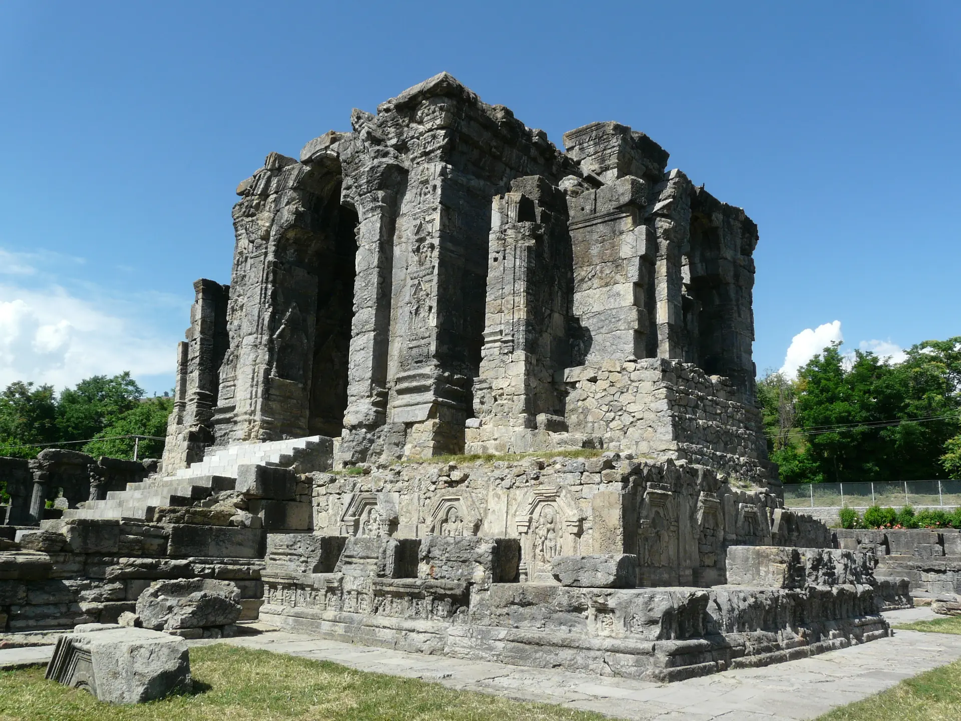 The tall grey stone central shrine of the Martand Sun Temple against a blue sky