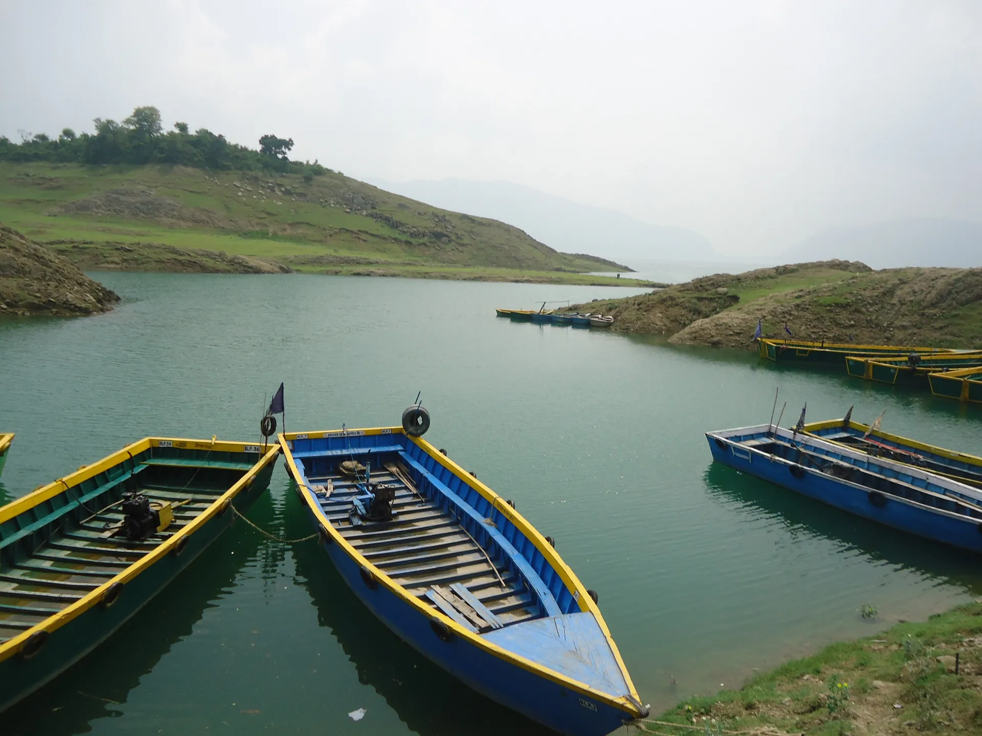 The reservoir stretching away between folded hills