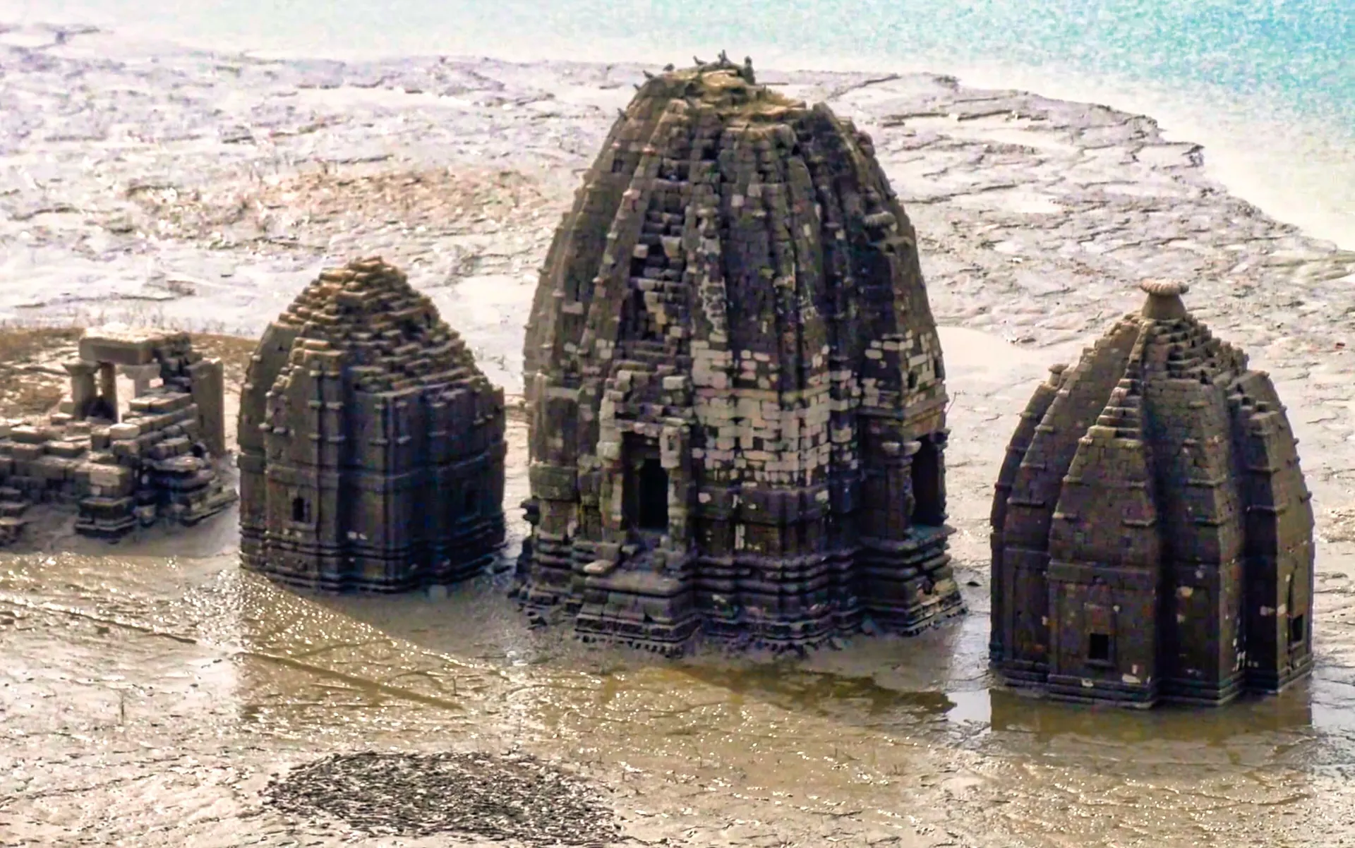 Stone temple spires of old Bilaspur standing out of the low water of Gobind Sagar