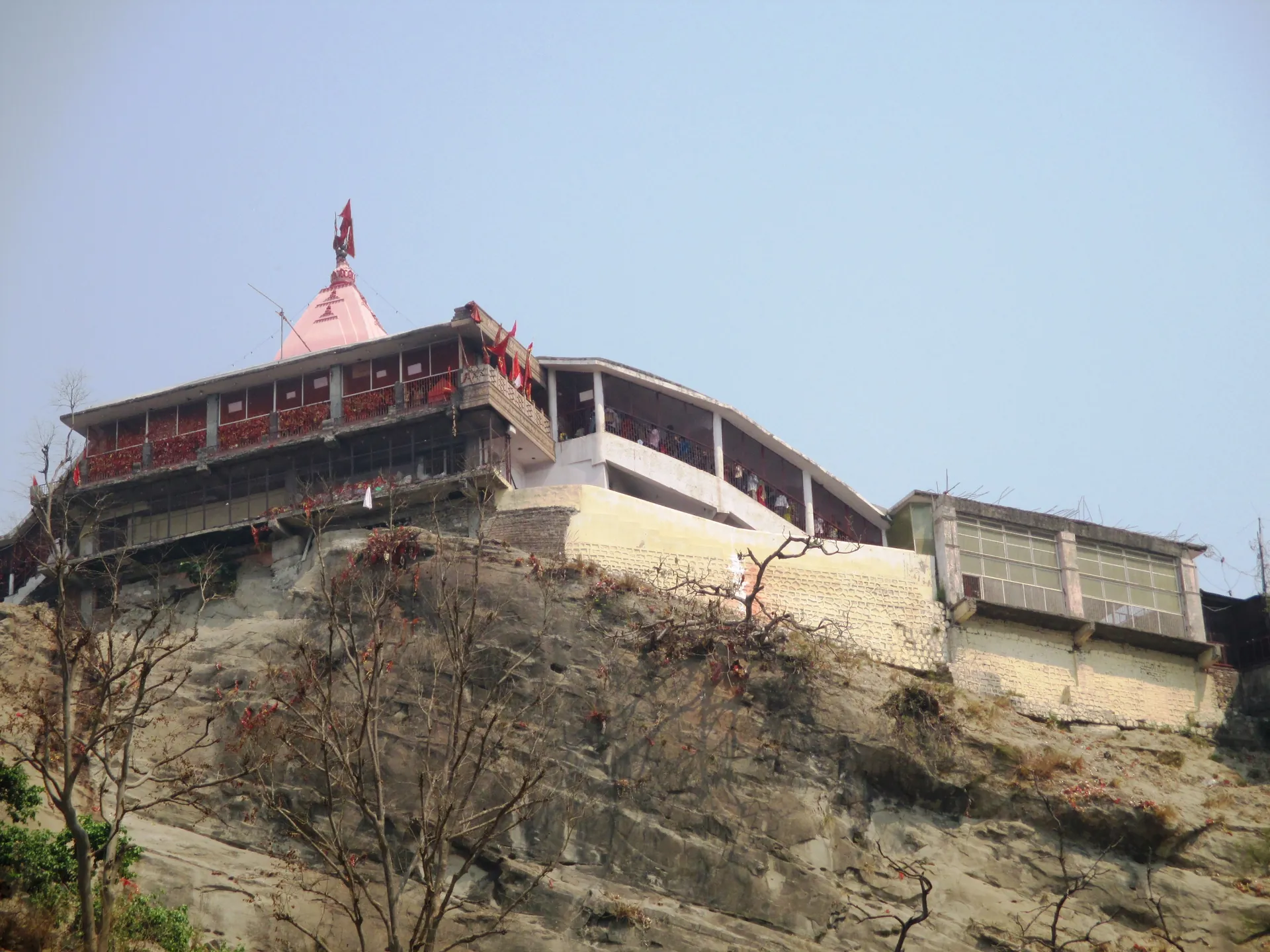 The Chandi Devi Temple on its rocky ridge above Haridwar, with a pink spire and balconies on the cliff edge