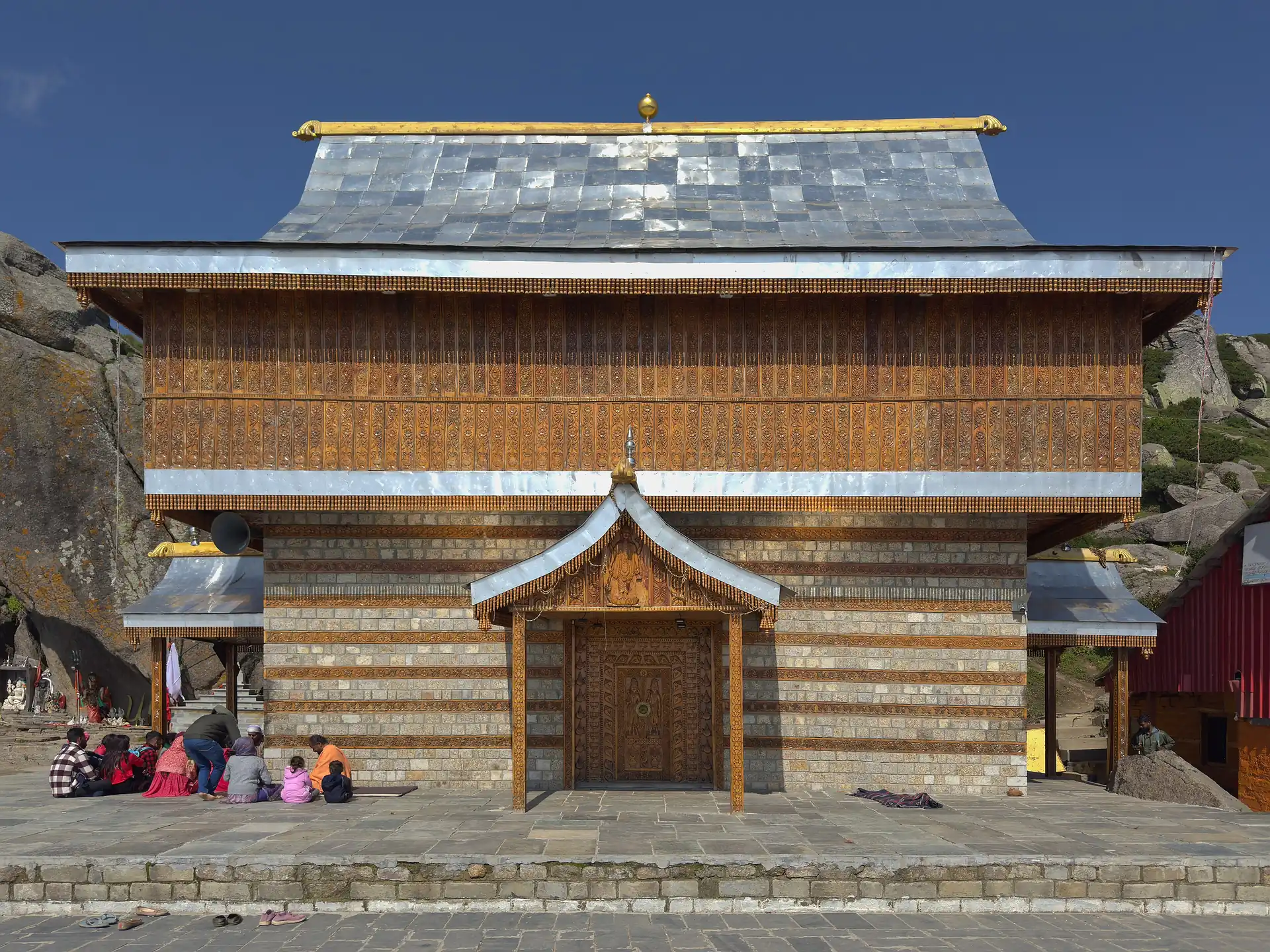 The timber temple of Shirgul Maharaj with a slate roof on the summit plateau of Churdhar
