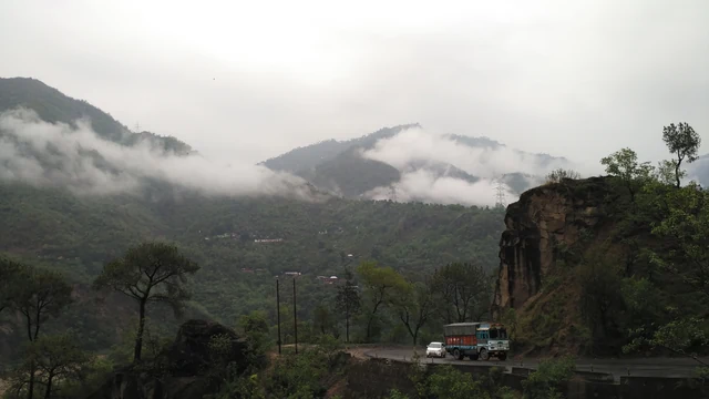 The highway along a cliff in monsoon mist