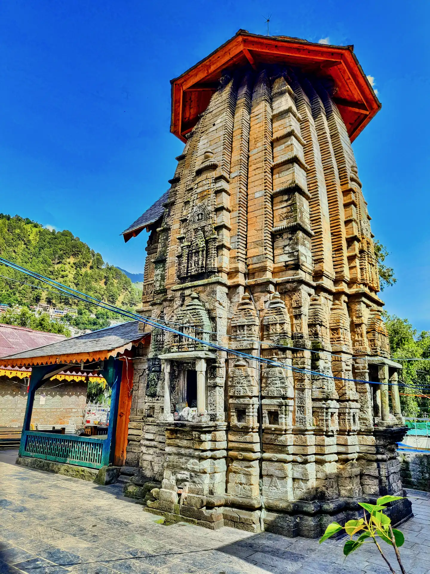The tall carved stone tower of Hari Rai Temple in Chamba under its wooden cap