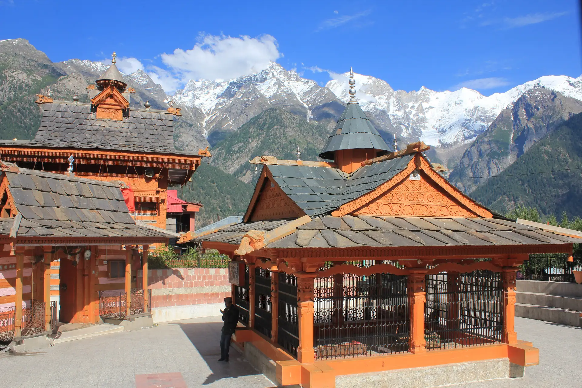 The slate-roofed Chandika Devi Temple complex at Kothi with snow peaks behind