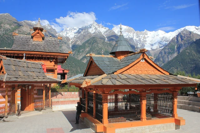 The slate-roofed Chandika Devi Temple complex at Kothi with snow peaks behind