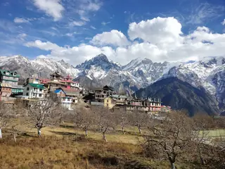 The wooden houses of Kalpa village with snow peaks of the Kinnaur Kailash range behind