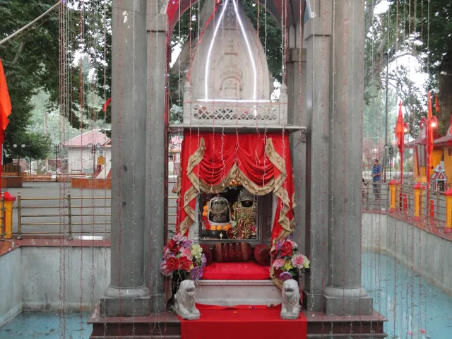 The red-draped shrine of the goddess Kheer Bhawani on a platform in the middle of the sacred spring