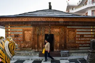 The carved wooden front of the temple at Bhekhli