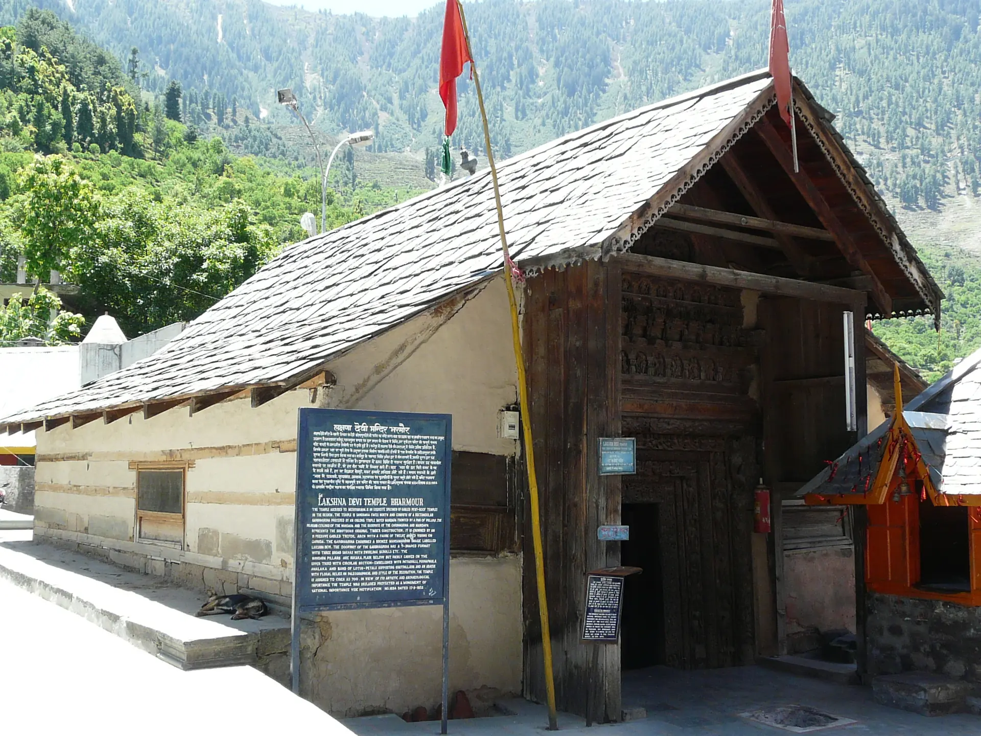 The Lakshana Devi Temple at Bharmour with a slate roof and a carved wooden doorway