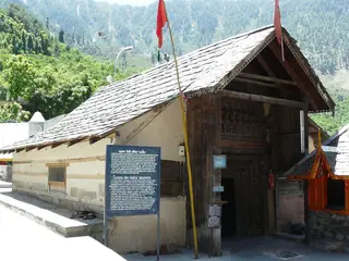 The Lakshana Devi Temple at Bharmour with a slate roof and a carved wooden doorway