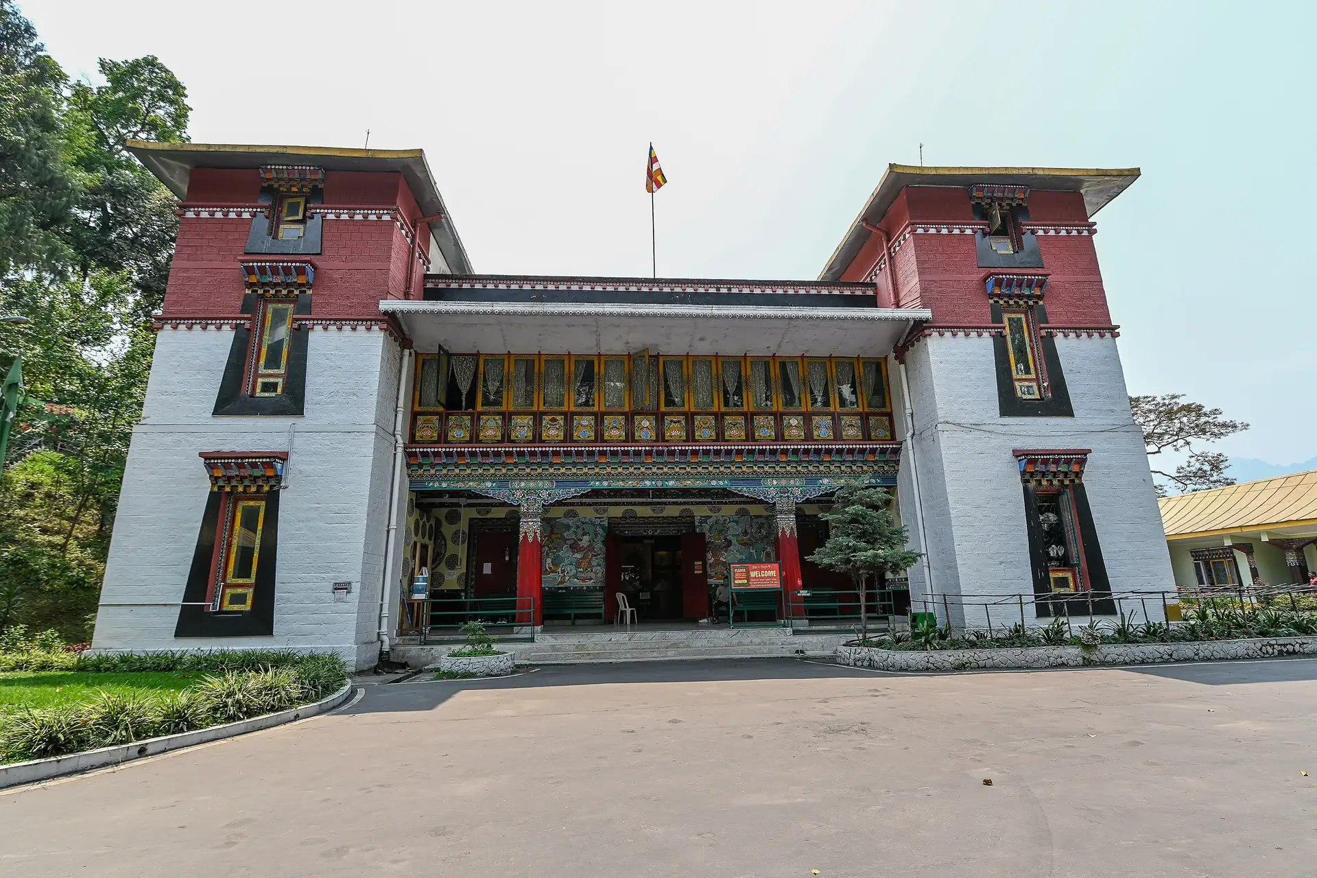 The red-and-white front of the Namgyal Institute of Tibetology in Gangtok with its two tall wings and a painted central porch