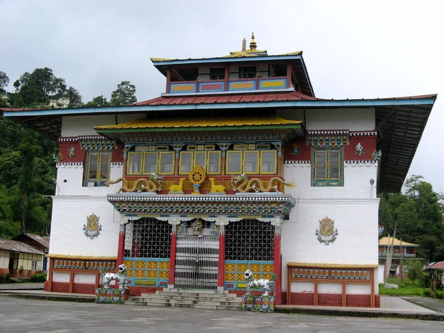 The white, red and gold front of Phodong Monastery with a blue-roofed upper hall, steps and a paved forecourt
