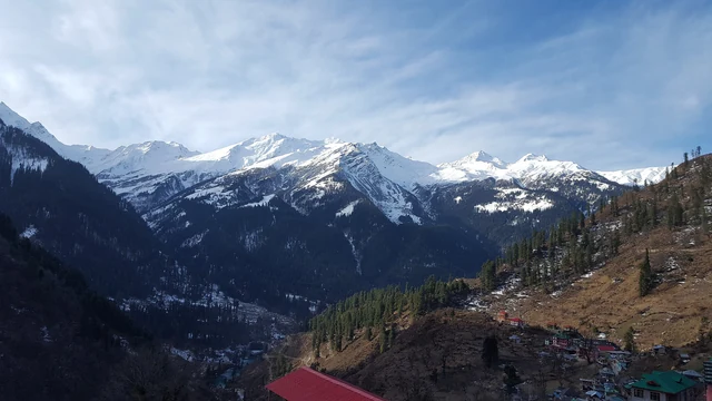 A high ridge of forest and snow above the Parvati side valleys